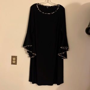 Cute black dress, with leopard trim, knee length.